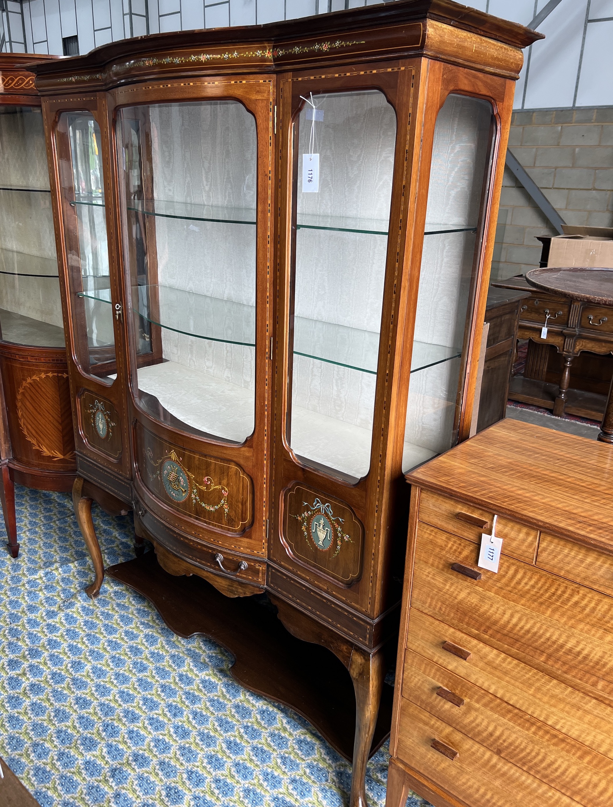 An Edwardian inlaid and painted mahogany bowfront display cabinet, width 136cm, depth 50cm, height 179cm
